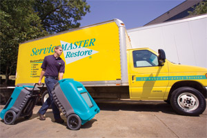 Frederick County, MD water damage restoration technician from ServiceMaster by Cross with dehumidifiers