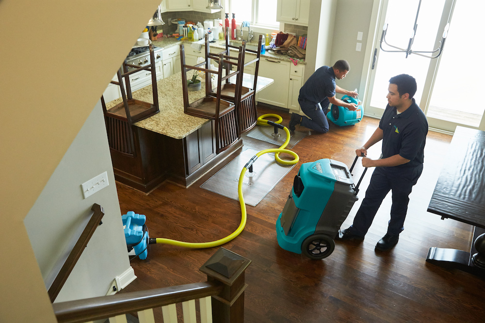 ServiceMaster Technicians cleaning water from house